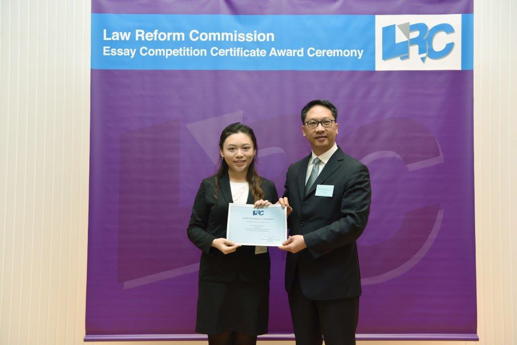 Mr Rimsky Yuen, SC, LRC Chairman, awarded a certificate to Miss Ho Wing Chi, Gigi