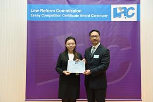 Mr Rimsky Yuen, SC, LRC Chairman, awarded a certificate to Miss Ho Wing Chi, Gigi